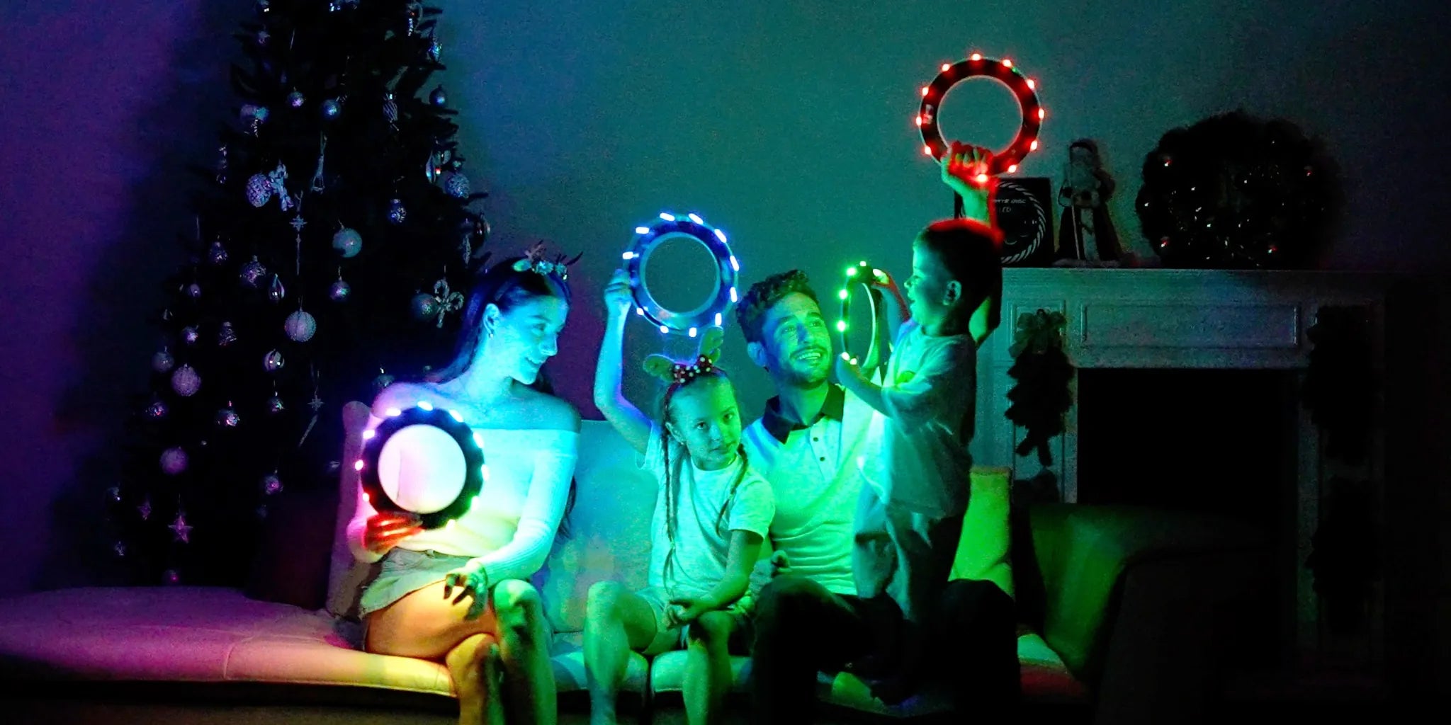 Happy family enjoying indoor active play with the illuminating TOSY Flying Ring RGB during Christmas celebration