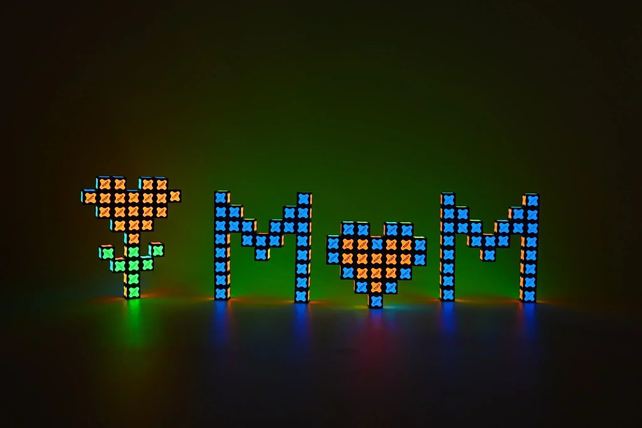 TOSY Magnet Cube 3x3 glowing in the dark arranged into MOM letters with flower and heart shapes for Mother's Day gift