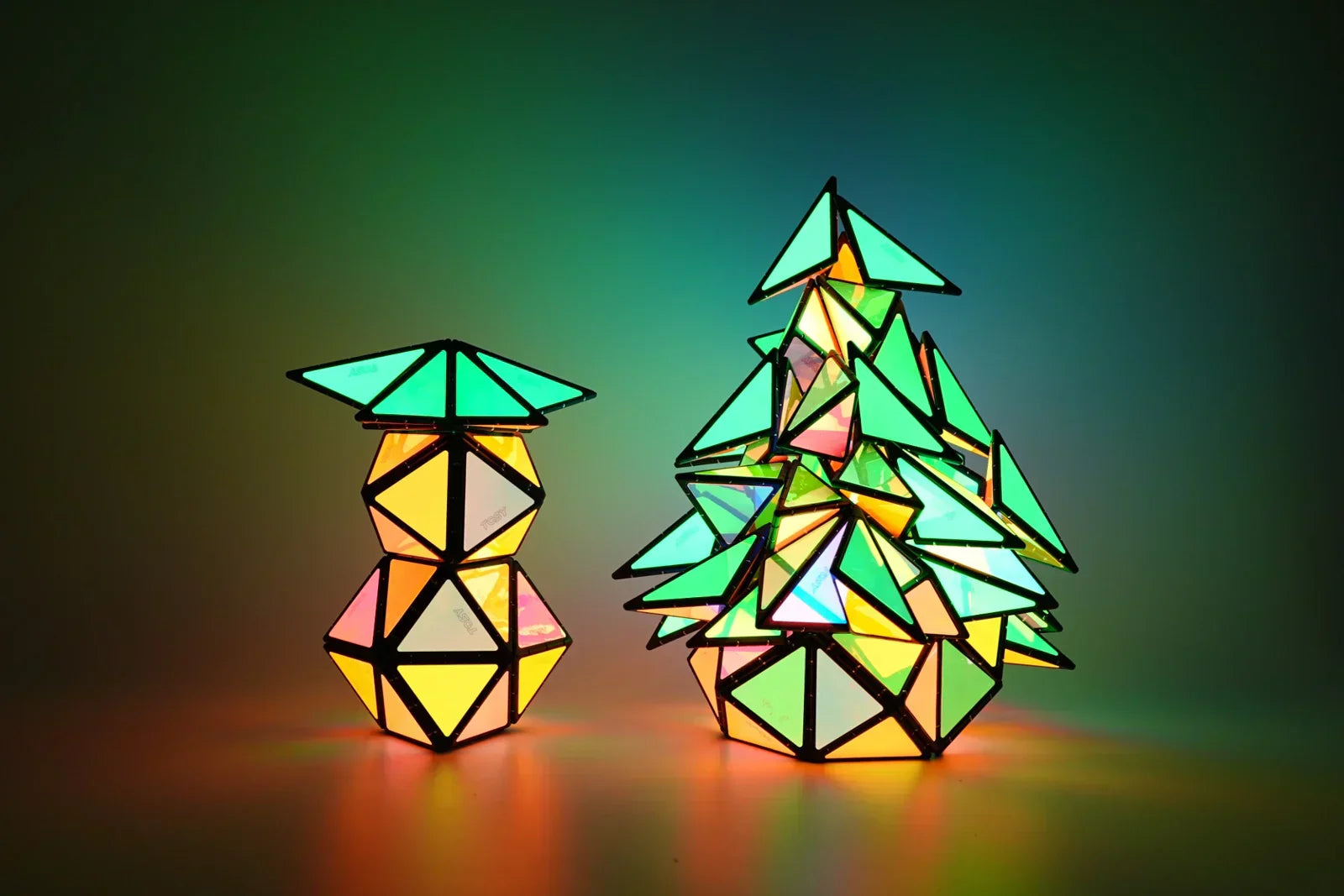 TOSY Magnetic Pyramid Glow arranged in Christmas tree shapes, colorful glowing magnetic building toy creating festive holiday patterns with illuminated pieces
