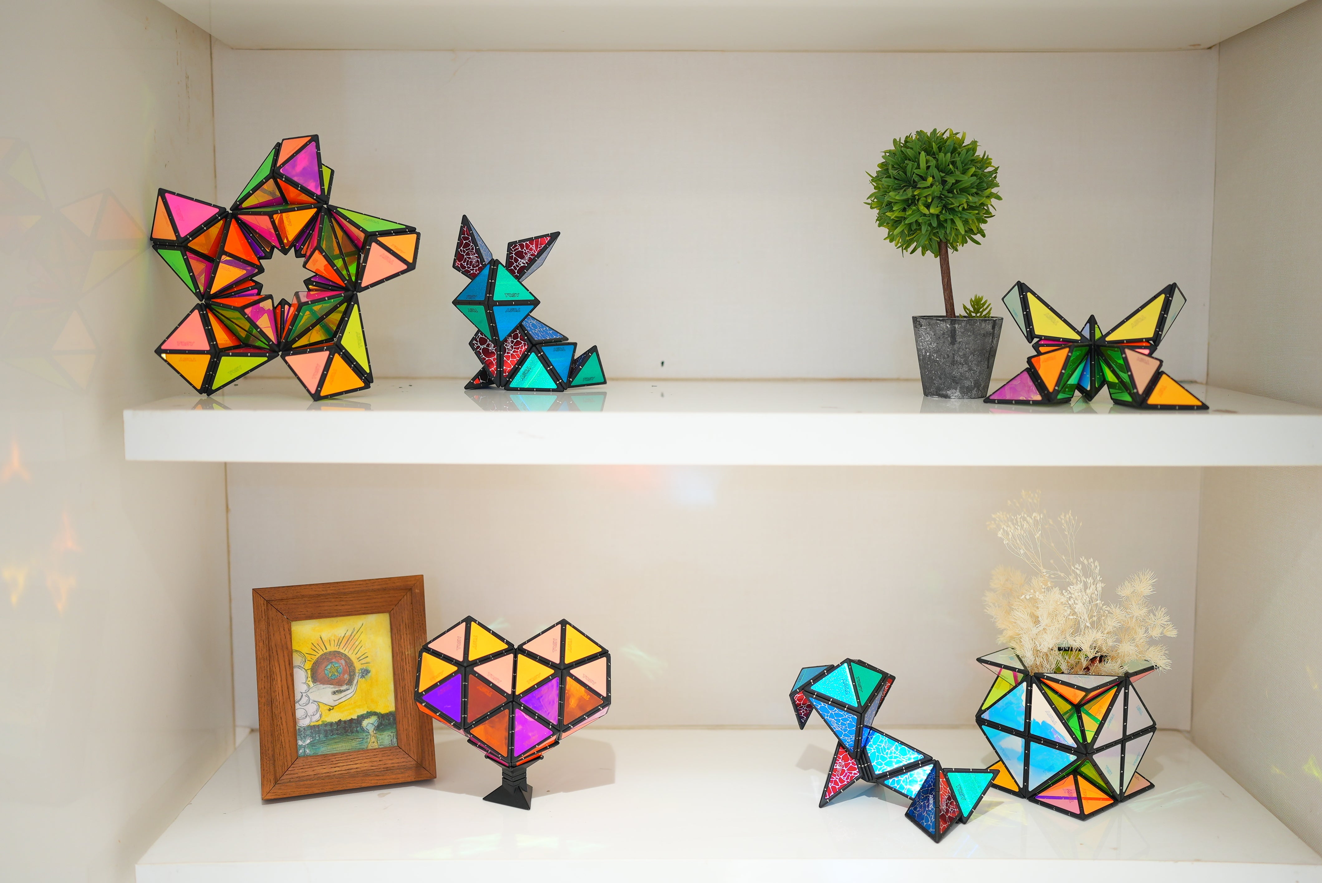 TOSY Magnet Pyramid toys arranged in various geometric shapes and displayed neatly on a shelf