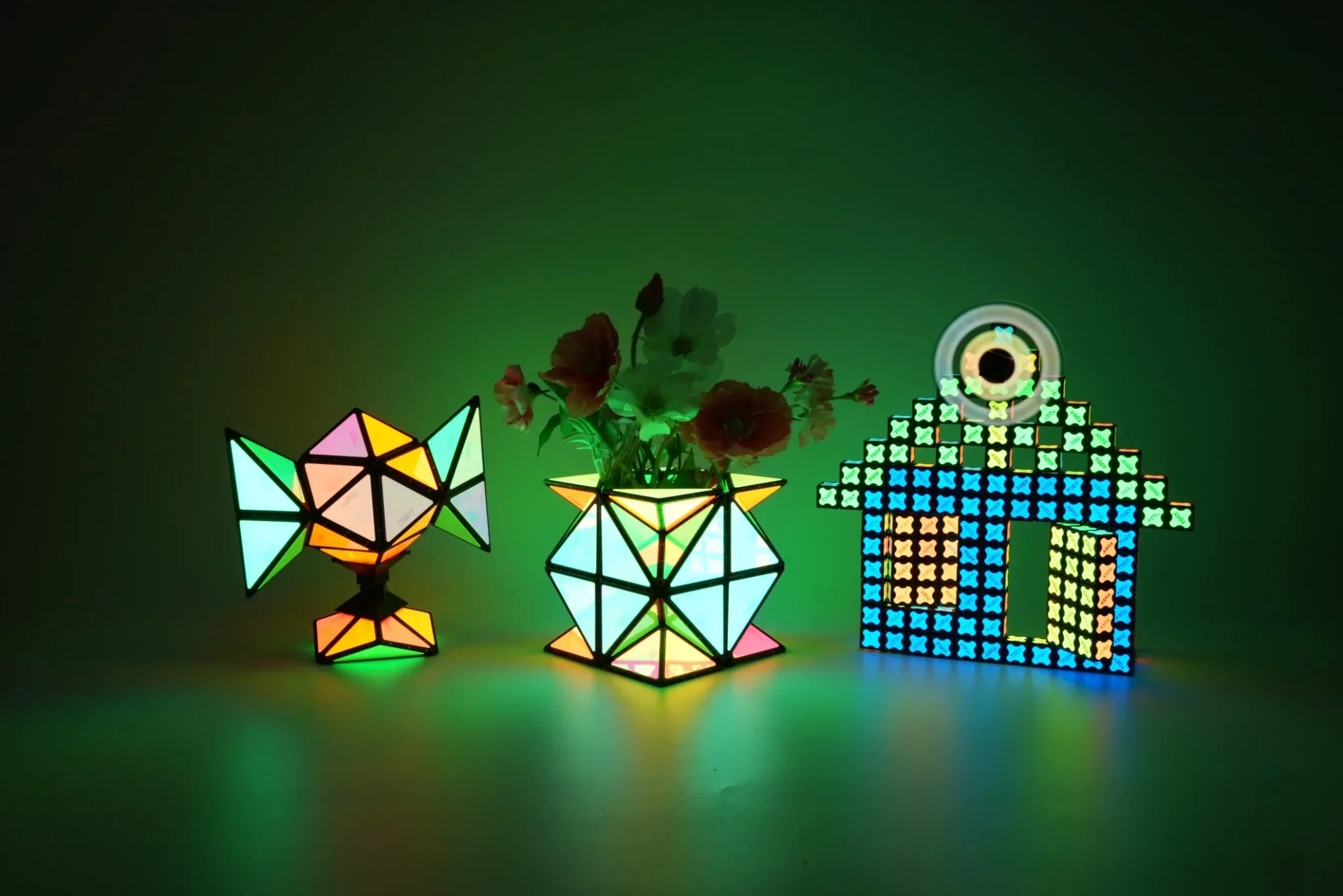 TOSY magnetic pyramid and magnet cube arranged into colorful glowing shapes, including a house and decorative structures, creative magnetic building toys for kids Christmas gifts