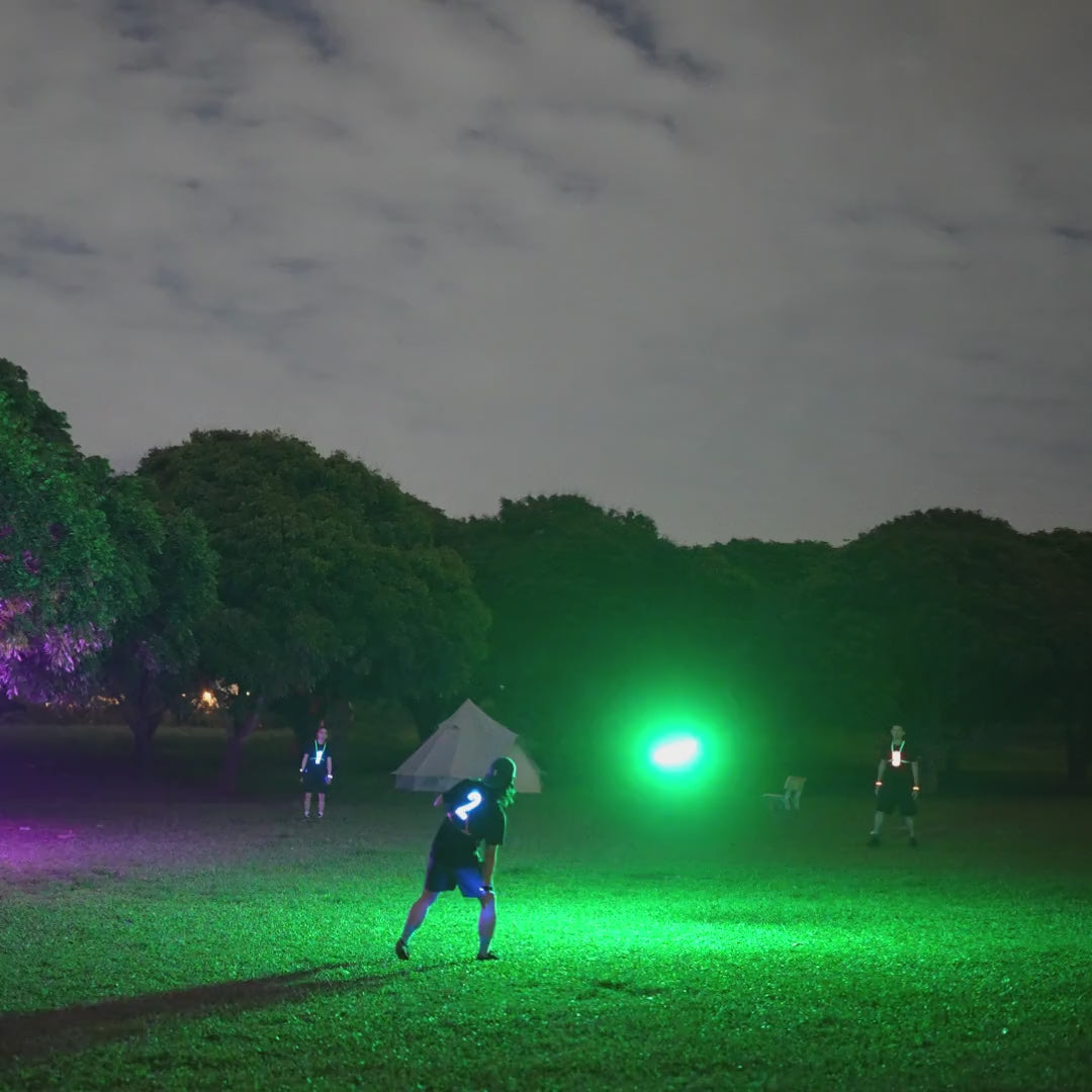 Load video: Friends playing with the TOSY Flying Disc RGB light up frisbee in the park, featuring bright LED lights, smooth flight, and exciting group play.