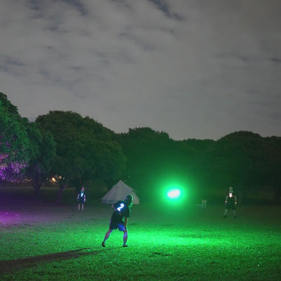Friends playing with the TOSY Flying Disc RGB light up frisbee in the park, featuring bright LED lights, smooth flight, and exciting group play.