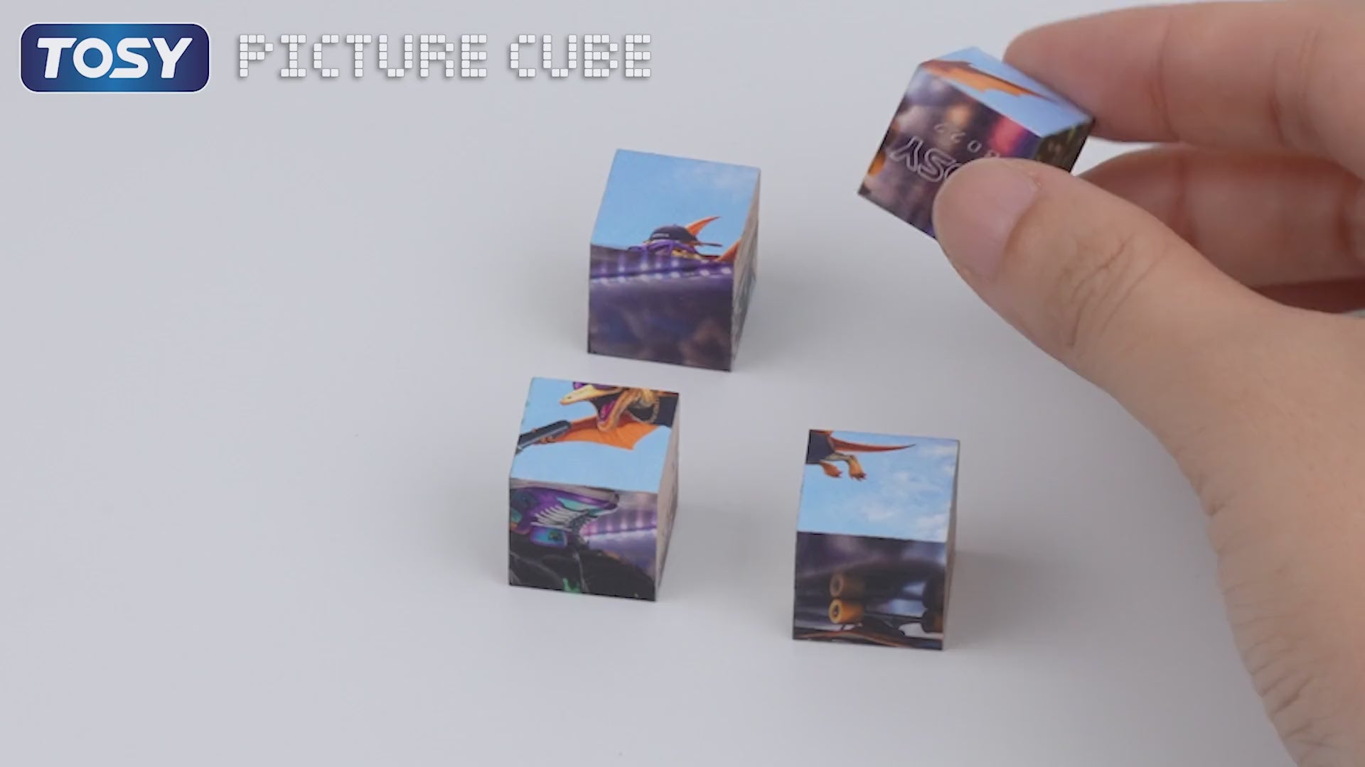 Load video: Video demonstrating TOSY Picture Cube Wacky Dinos magnetic blocks forming a completed puzzle and converting into 6 unique dino designs on a shelf