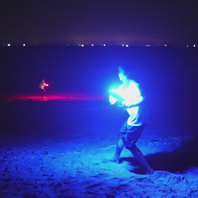 Kids playing with the TOSY Flying Disc RGB on the beach, demonstrating long-distance throws, easy catches, and fun outdoor frisbee games.
