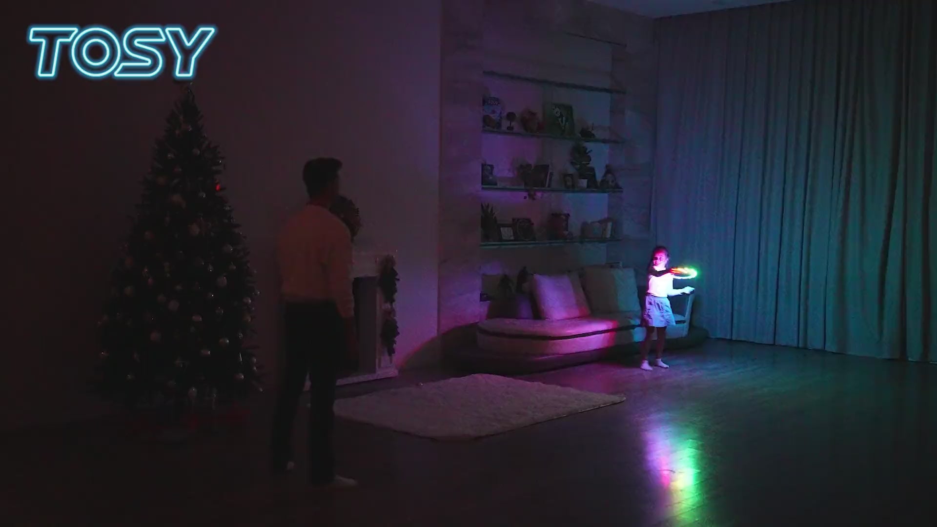 Load video: Family and kids playing with TOSY Flying Ring RGB at night, super bright LED glowing flying ring outdoor game