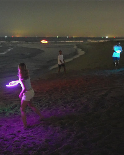 Kids playing with the TOSY Flying Ring on the beach, demonstrating smooth throws, easy catches, and active outdoor fun.