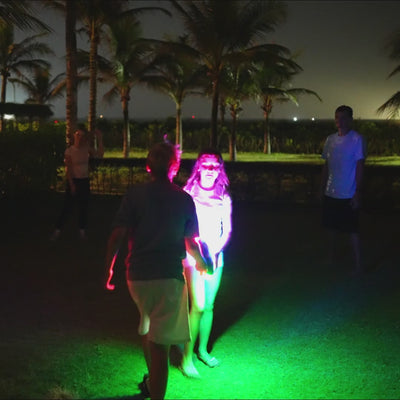 Family of four playing with the TOSY Flying Disc RGB in the backyard, enjoying LED frisbee games, easy catches, and active family fun.